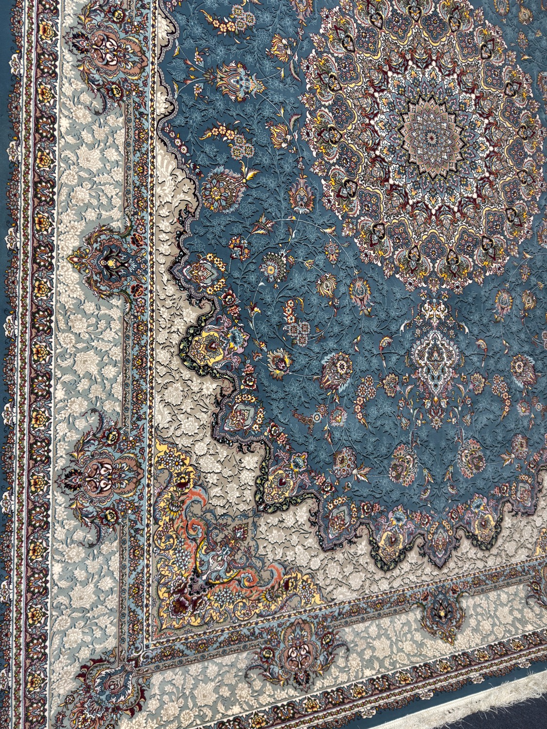 Persian rug with blue floral medallion on cream